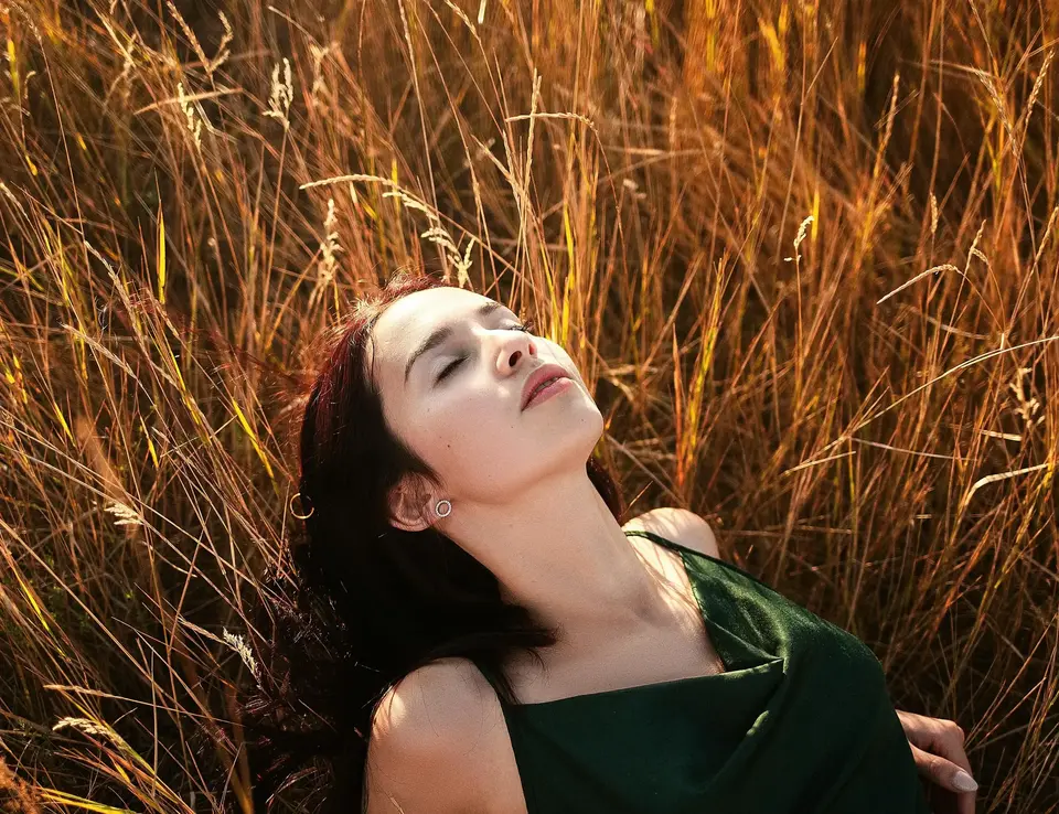 a woman lying in tall grass