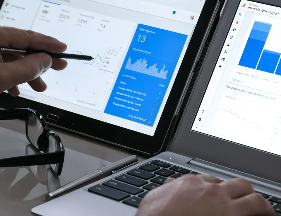 a person using a laptop and a pen