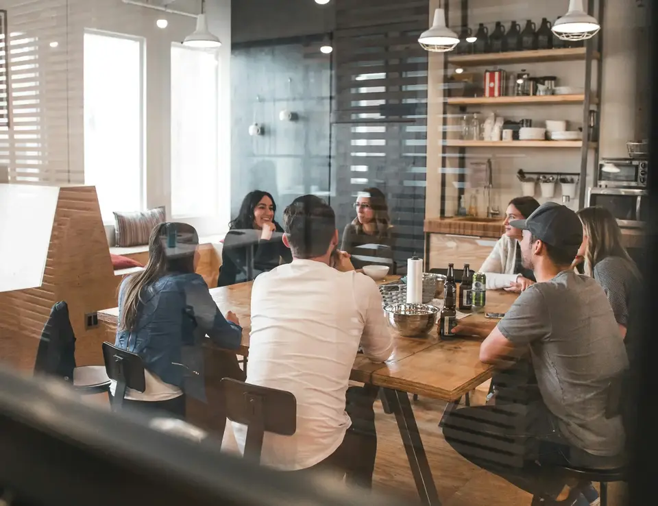 a group of people sitting around a table