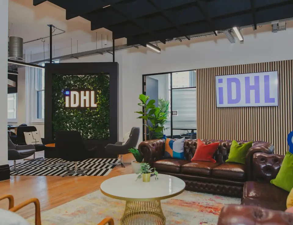 a room with a couch and chairs