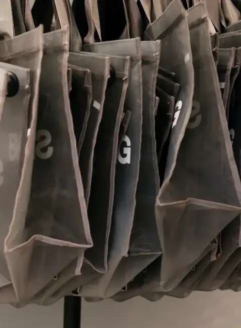 a group of bags on a rack