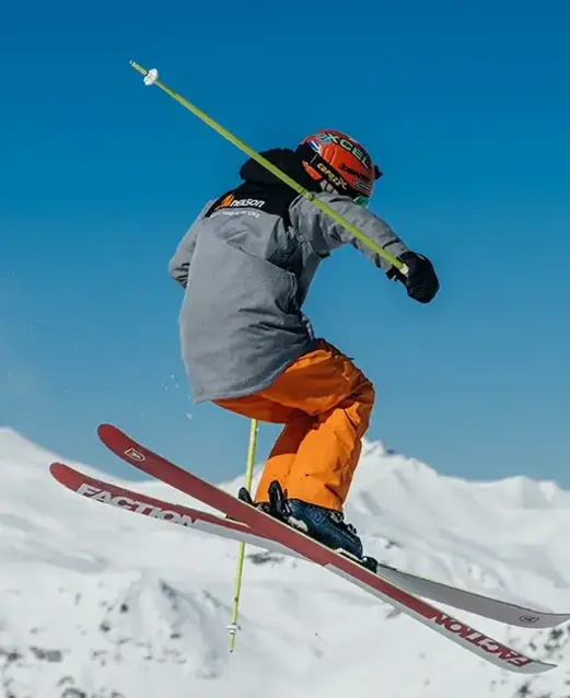 Skier making a jump on a snowy mountain 