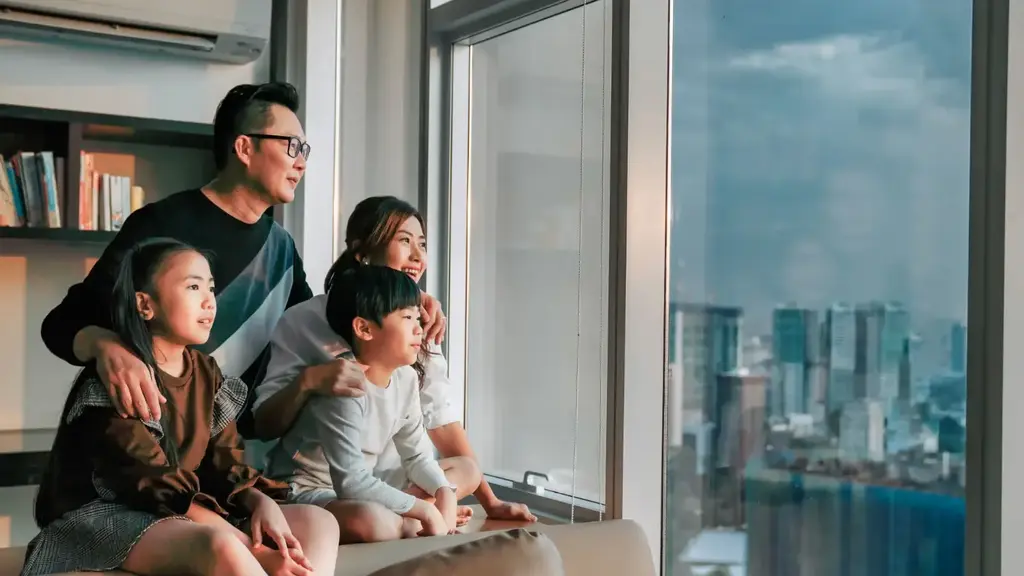 a group of people sitting on a couch looking out a window