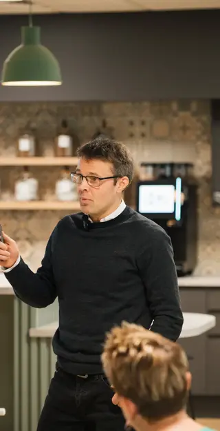 a man standing in front of a whiteboard