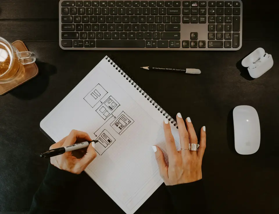 a person drawing on a notebook