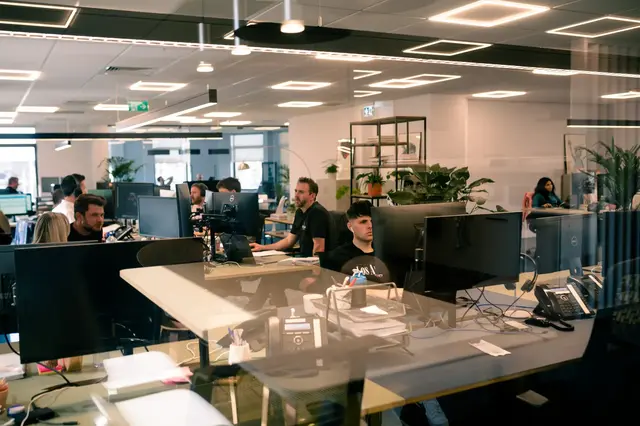 a group of people sitting at computers