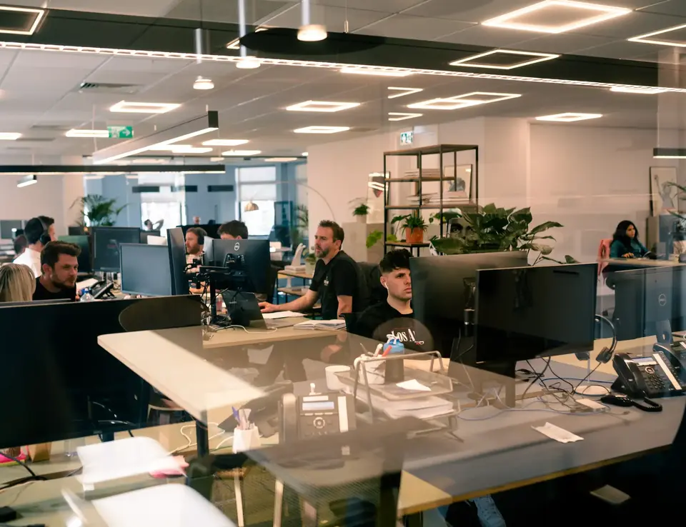 a group of people sitting at computers