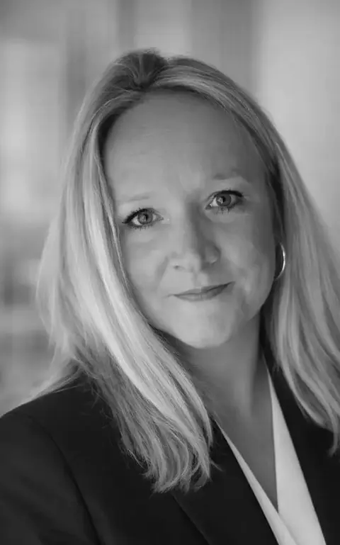 a woman with blonde hair wearing a suit