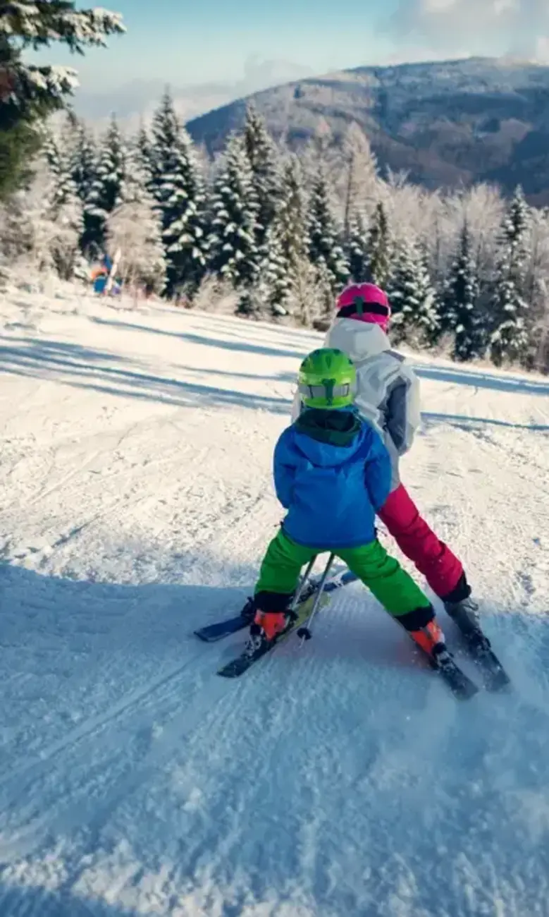 Two children skiing