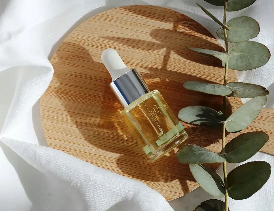 a bottle of oil on a wooden plate