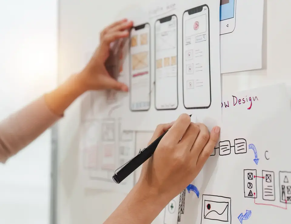 a person drawing on a white board