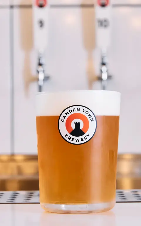 a glass of beer on a counter