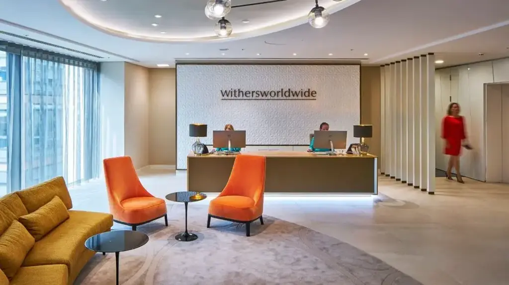 a lobby with a desk and chairs