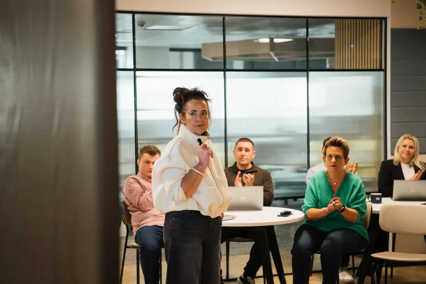 a woman standing in front of a group of people