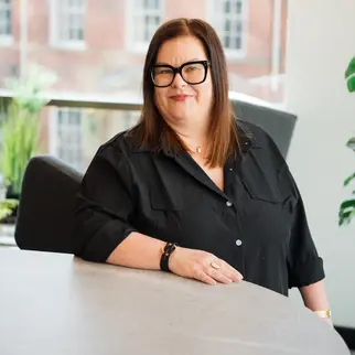 a woman in black shirt and glasses