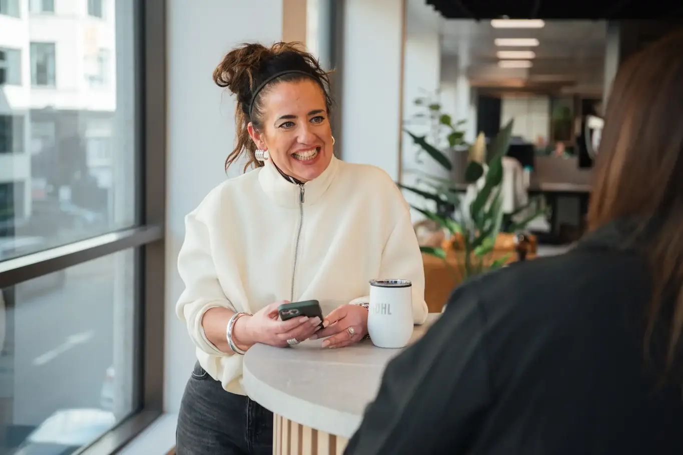 a woman smiling at a table