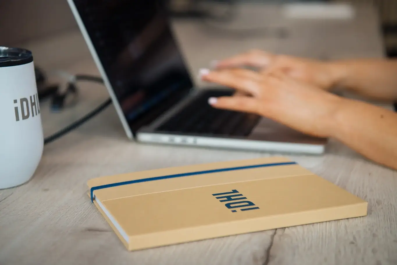 a hand typing on a laptop