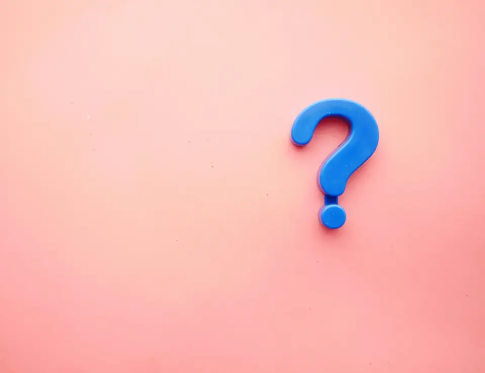 a blue question mark on a pink background