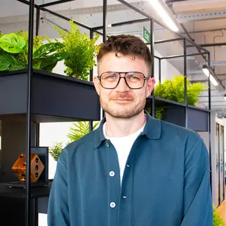 a man wearing glasses and a blue shirt