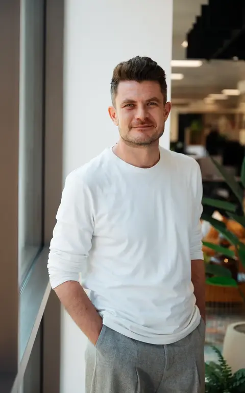 a man wearing glasses and a blue shirt