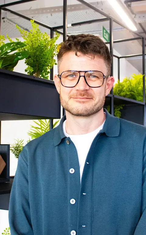 a man wearing glasses and a blue shirt
