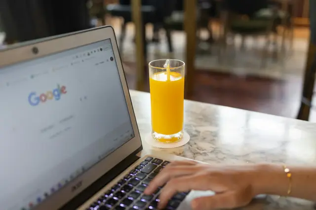 a hand typing on a laptop