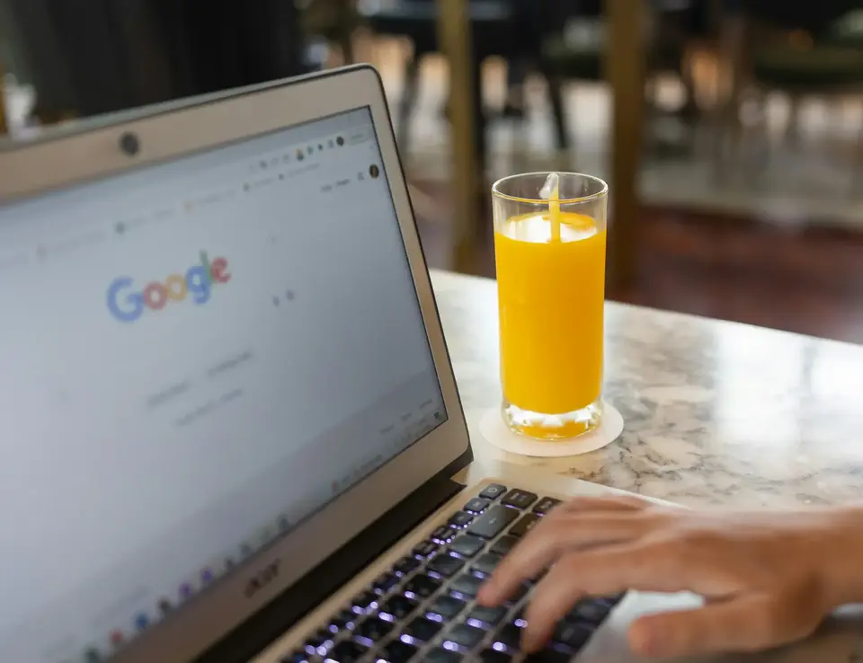 a hand typing on a laptop