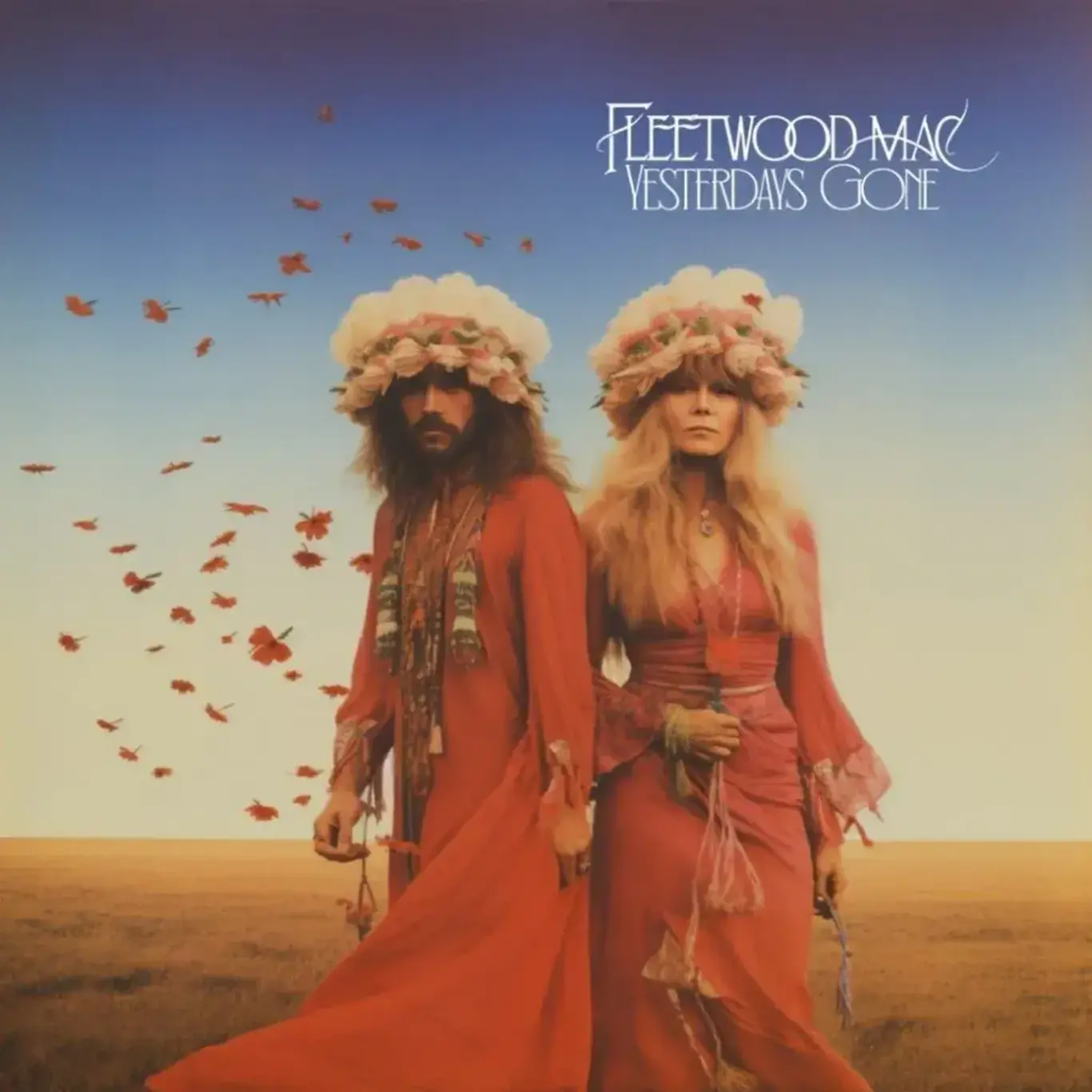 a man and woman in red dresses and flowers on their head