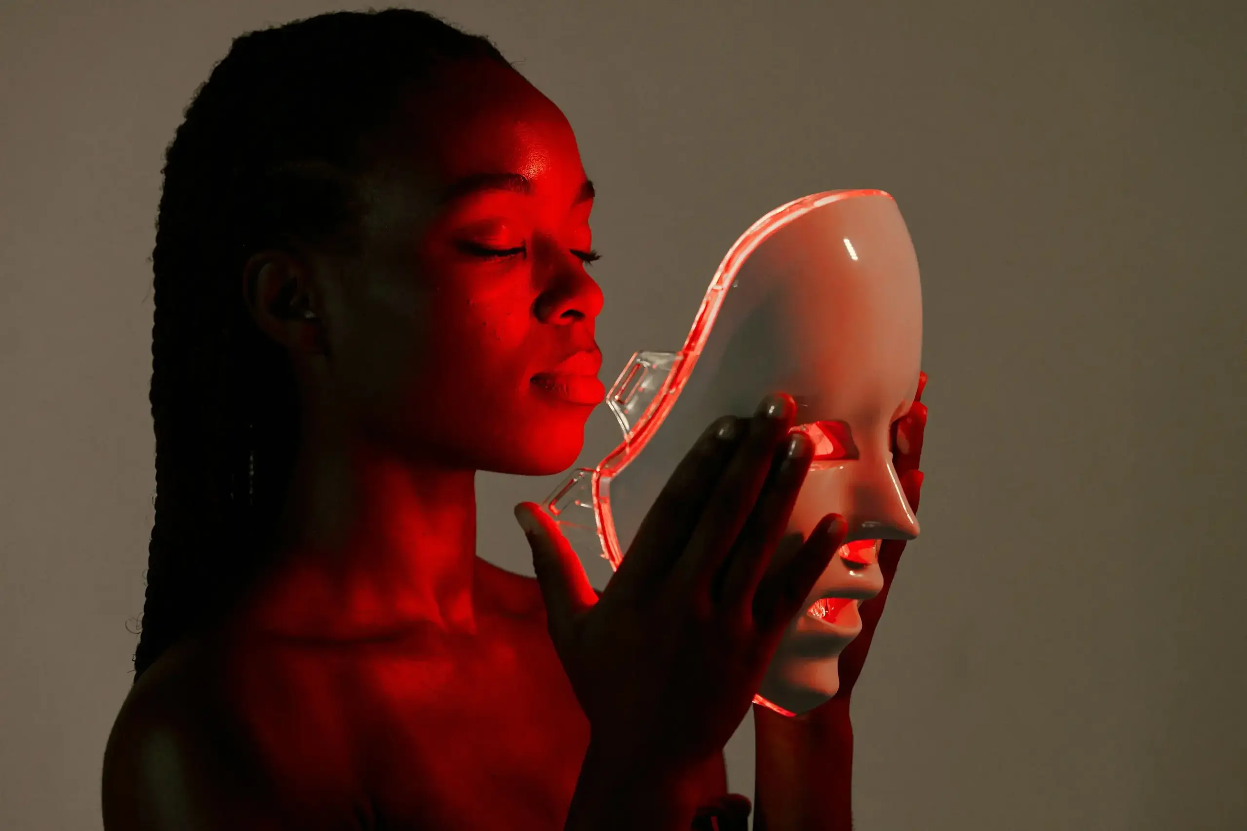 a woman holding a white mask