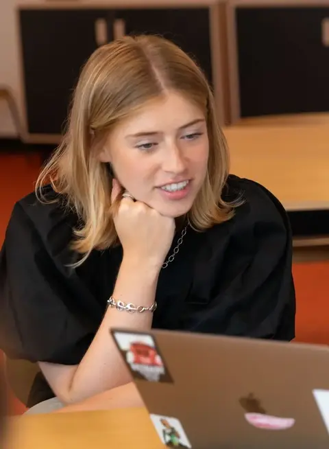 a man and woman looking at a laptop