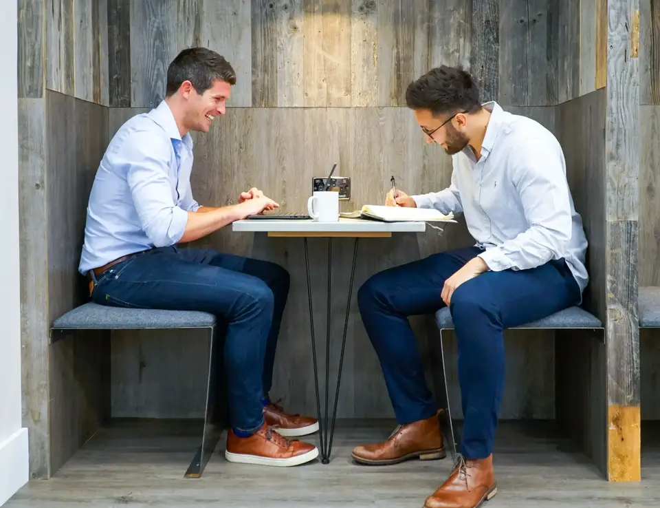 two men sitting at a table