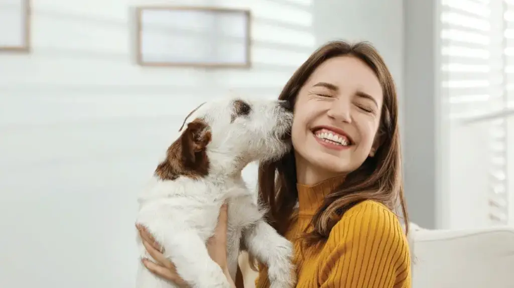 a woman holding a dog