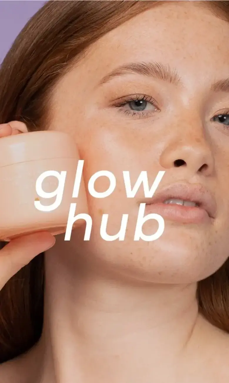 a woman holding a cream container