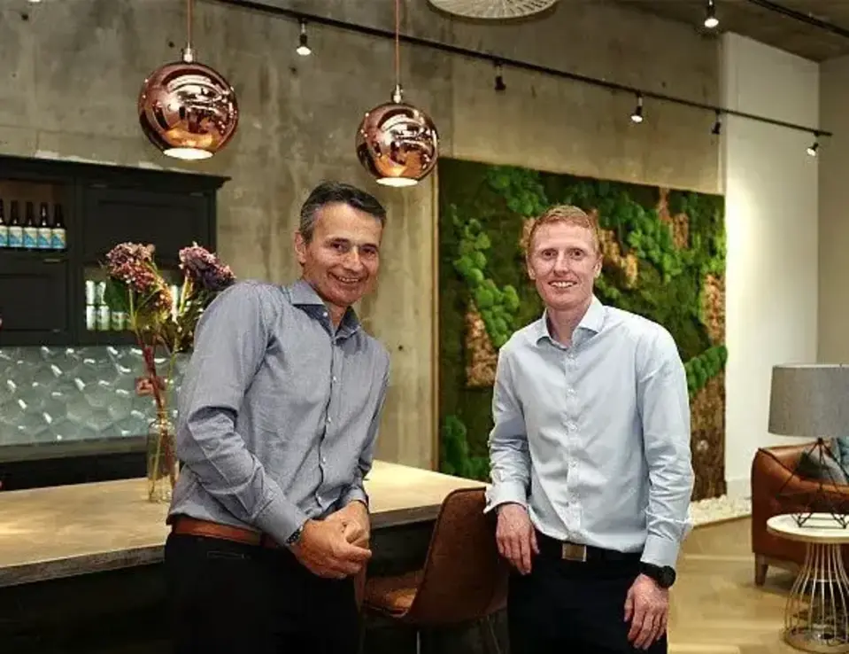 two men standing in a room