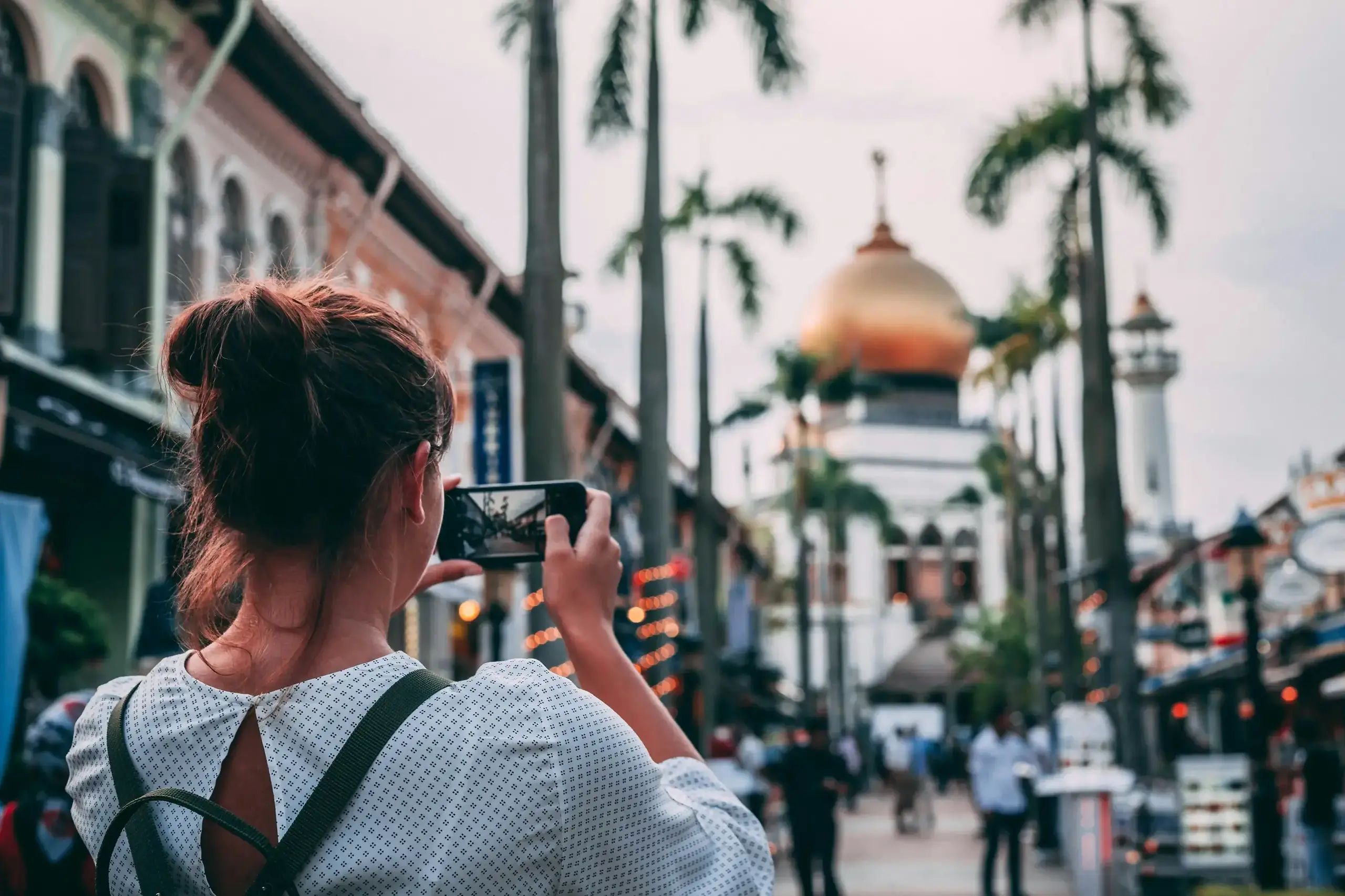Girl taking a photo on the streets
