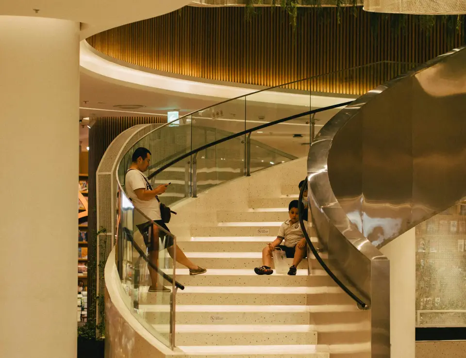 a group of people sitting on a spiral staircase