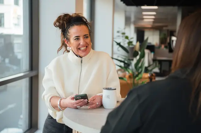 a woman smiling at a table
