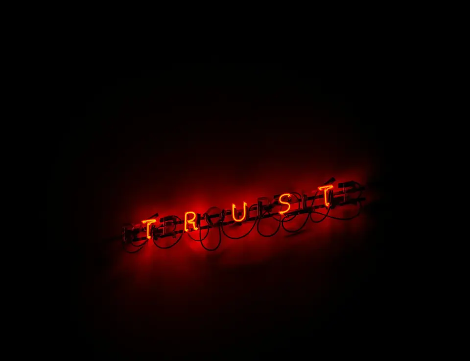 a red neon sign with letters
