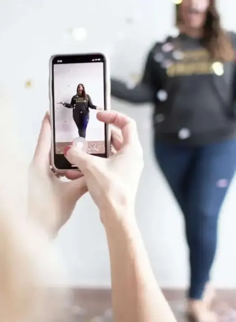 a person taking a picture of a woman