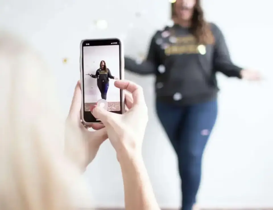 a person taking a picture of a woman