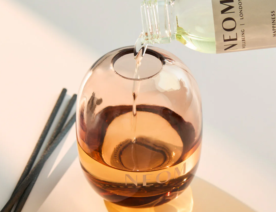 NEOM (IDHL client) oil being poured into a room diffuser