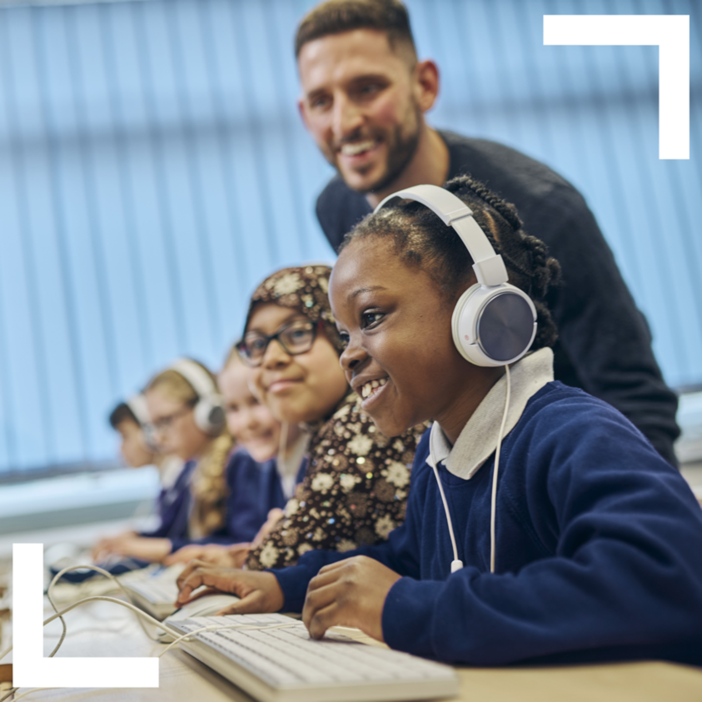 Young children wearing headphones in a classroom