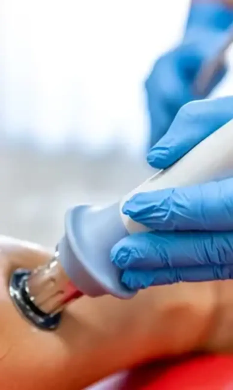 Doctor scanning a patient's arm with a handheld transducer