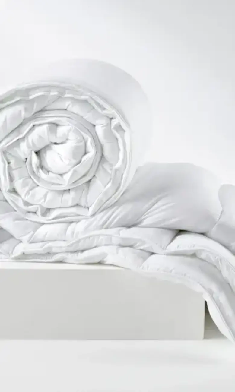 a white blanket rolled up on a white surface