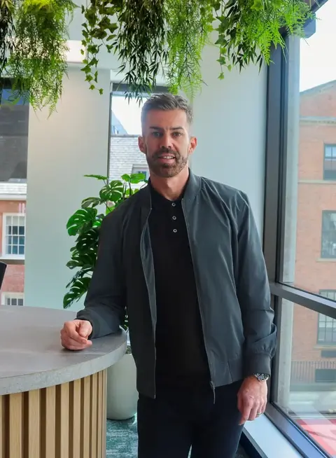 A man leaning on a table