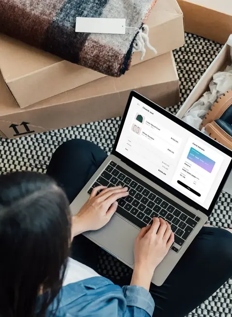 a woman sitting on the floor with a laptop