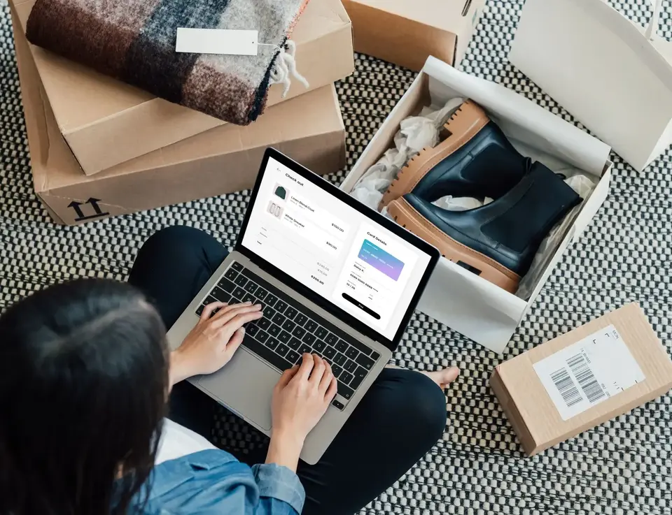 a woman sitting on the floor with a laptop