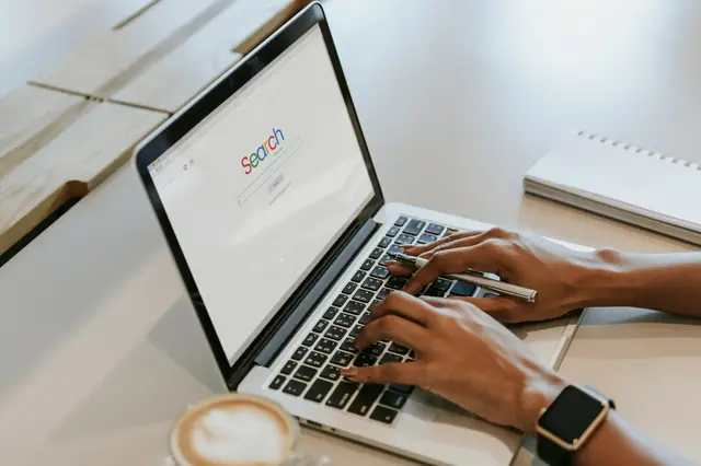 a person typing on a laptop