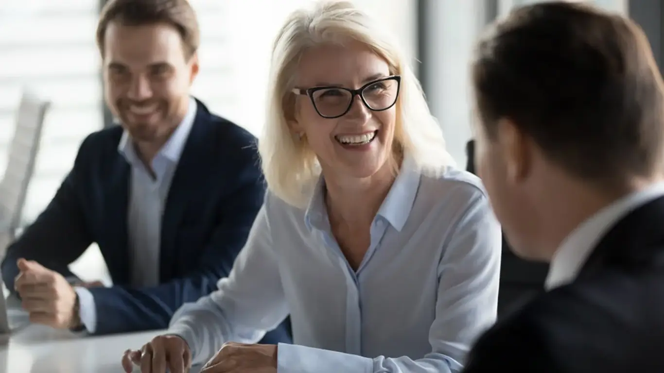 a woman smiling at a table
