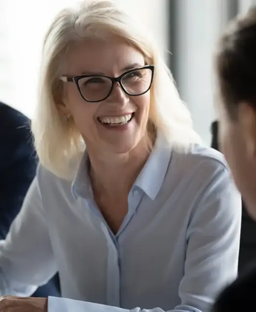 a woman smiling at a table